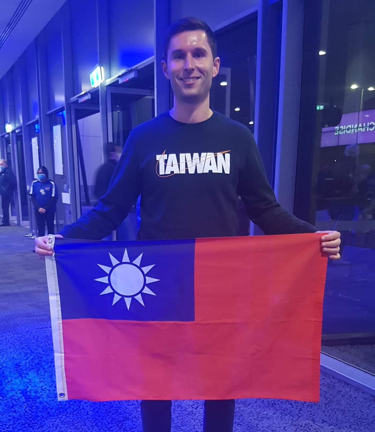 A man holding a Taiwan flag.