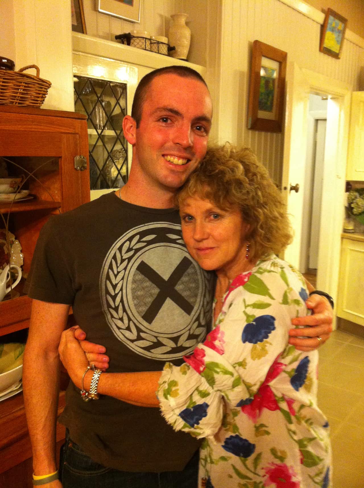 A woman hugging a young man 