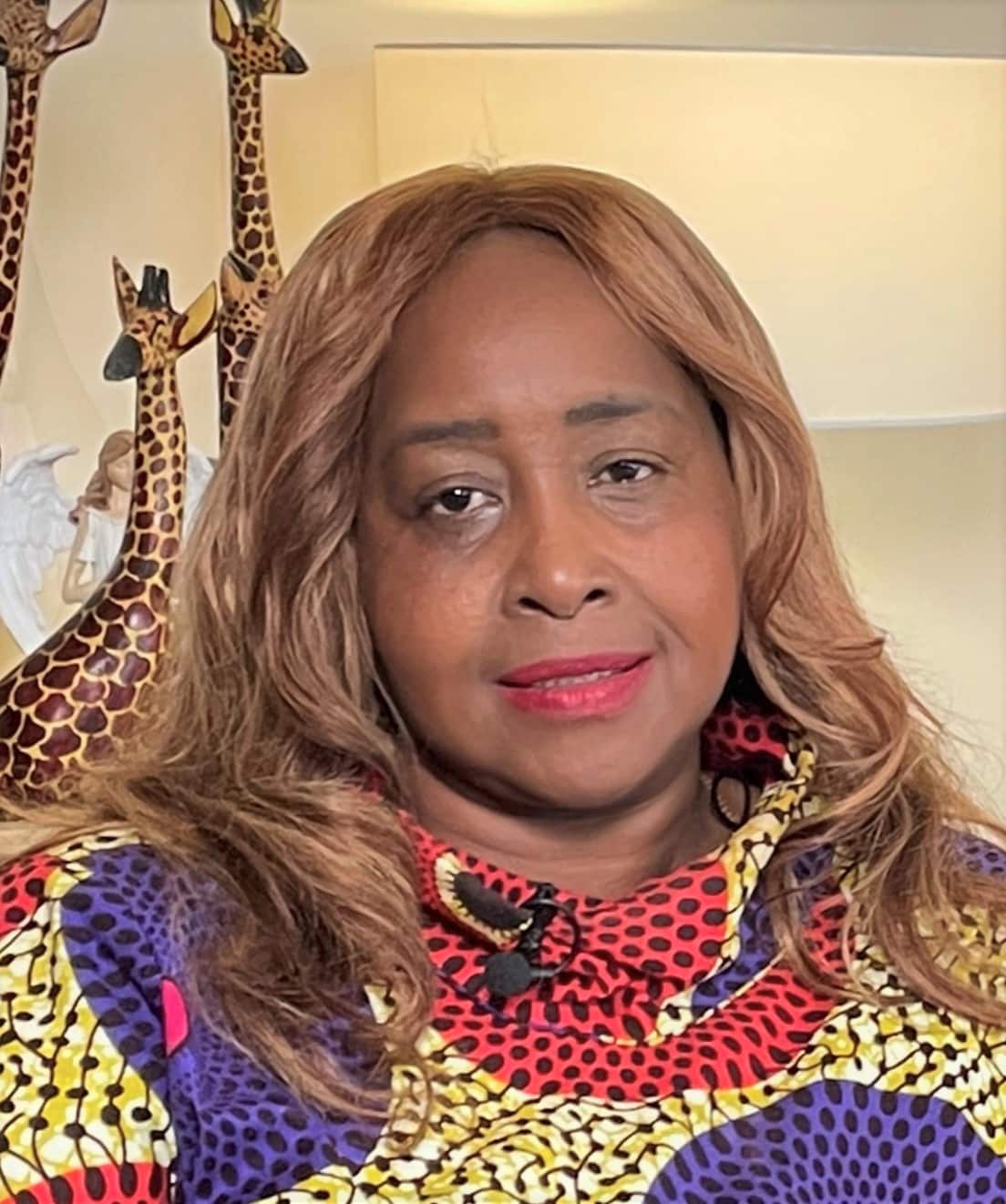 Emily Korir wearing a bright coloured top