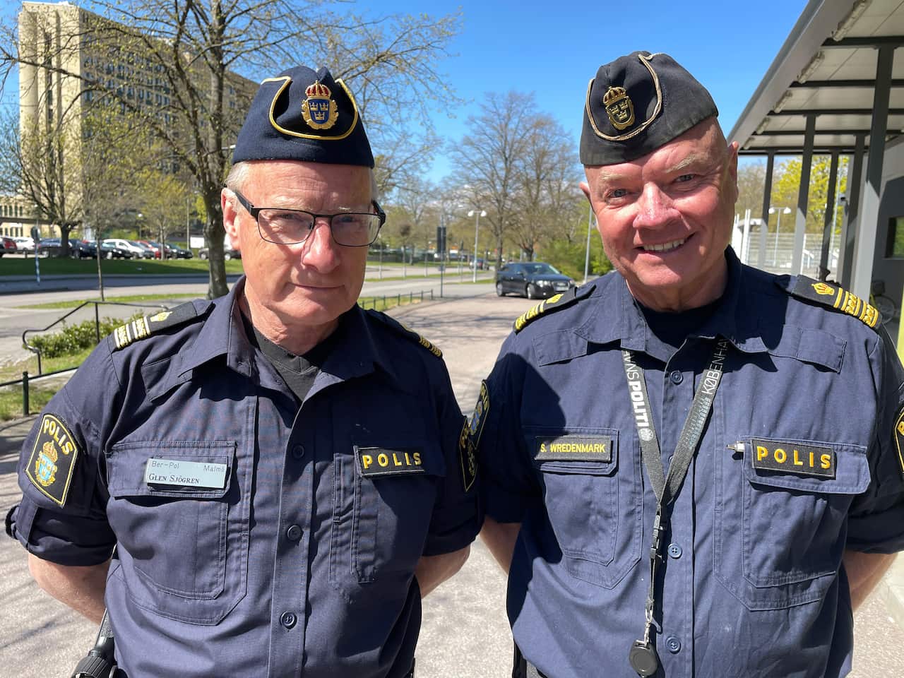 Two men with police officer uniforms on. 