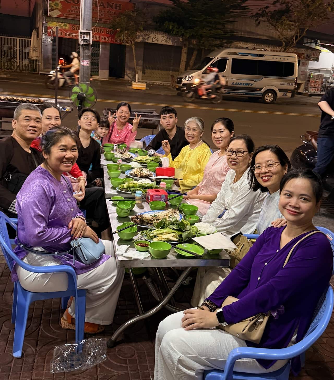 A family sits around a table of food.