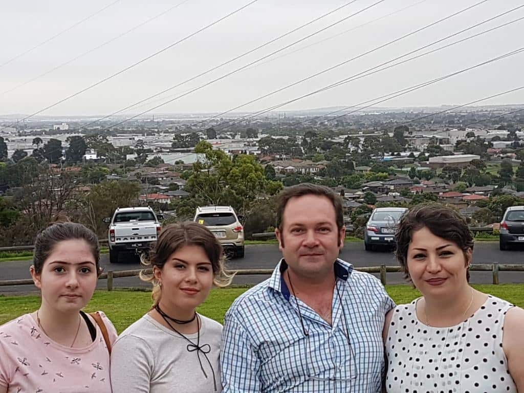 Helia Diba (left) with her sister, father and mother posing for a photograph outside