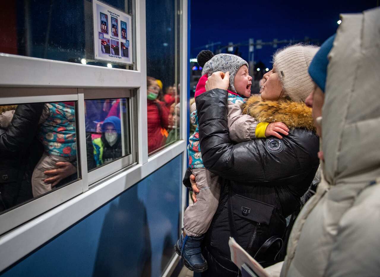 Ukrainian women and children are seen at the Slovak-Ukrainian border crossing at Vysne Nemecke