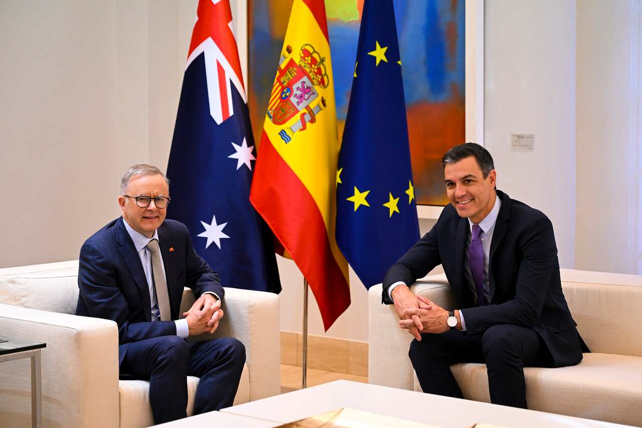 Australian Prime Minister Anthony Albanese (left) and Spanish Prime Minister Pedro Sanchez sitting in arm chairs and talking.
