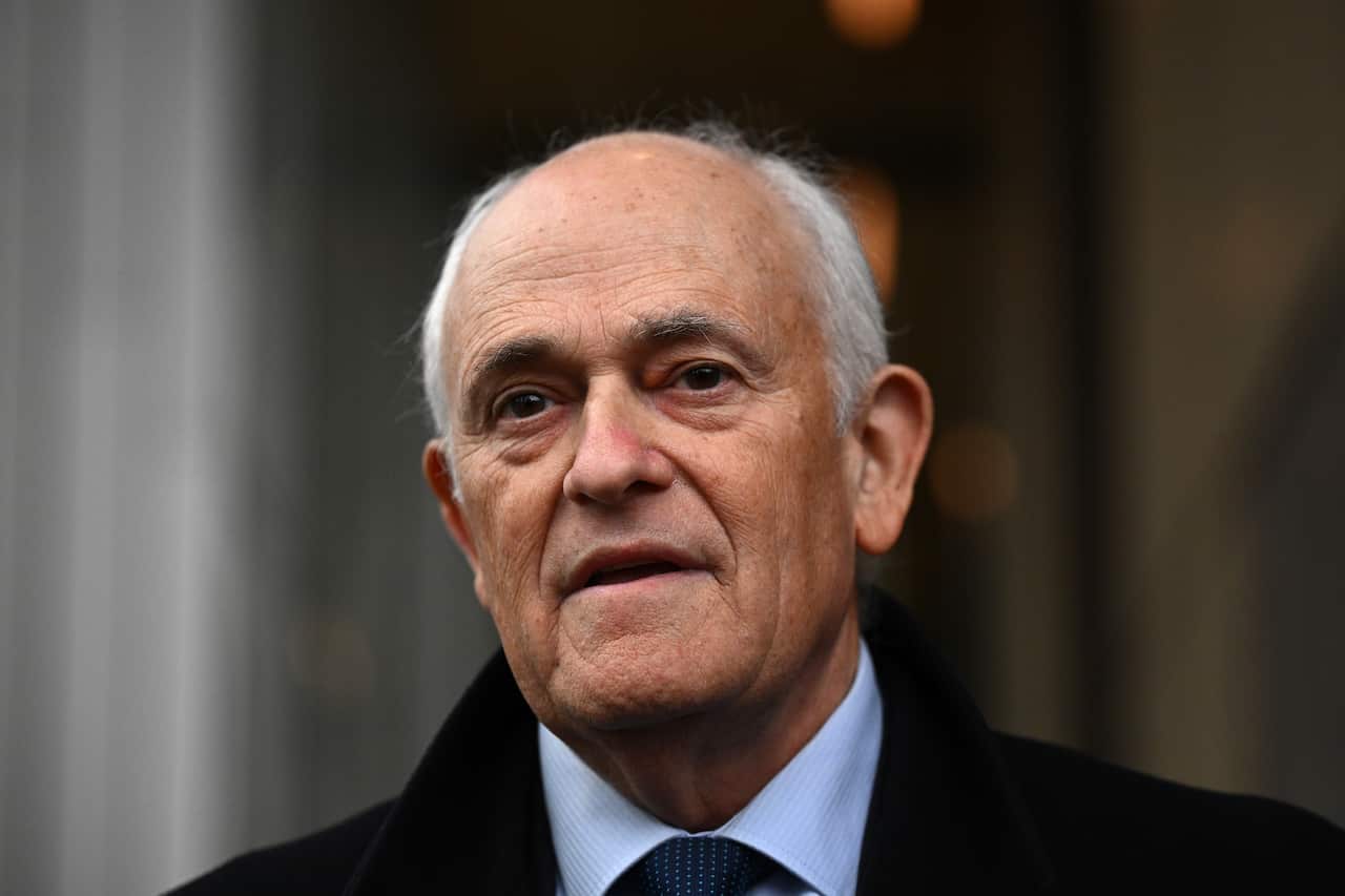 A man in a suit is speaking.