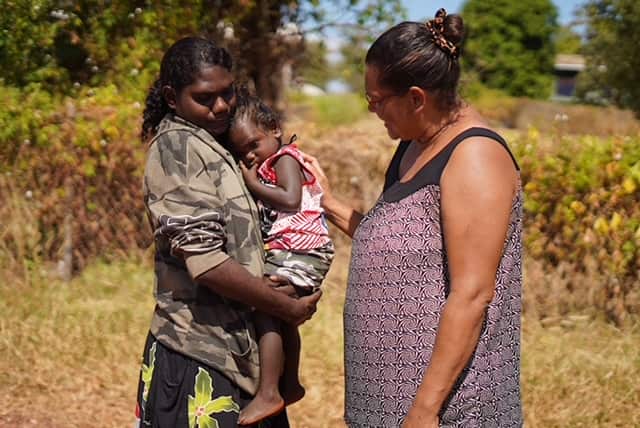 Bettina Danganbarr (right) talking with a woman holding a child
