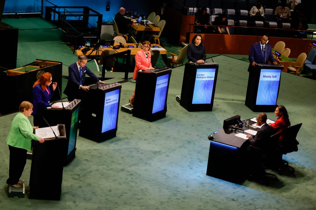 Six people standing at podiums.