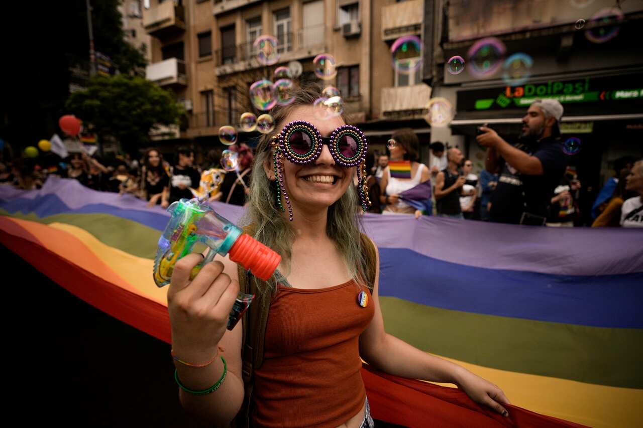 A girl shoots bubbles during the gay pride parade in Bucharest, Romania, Saturday, July 9, 2022.