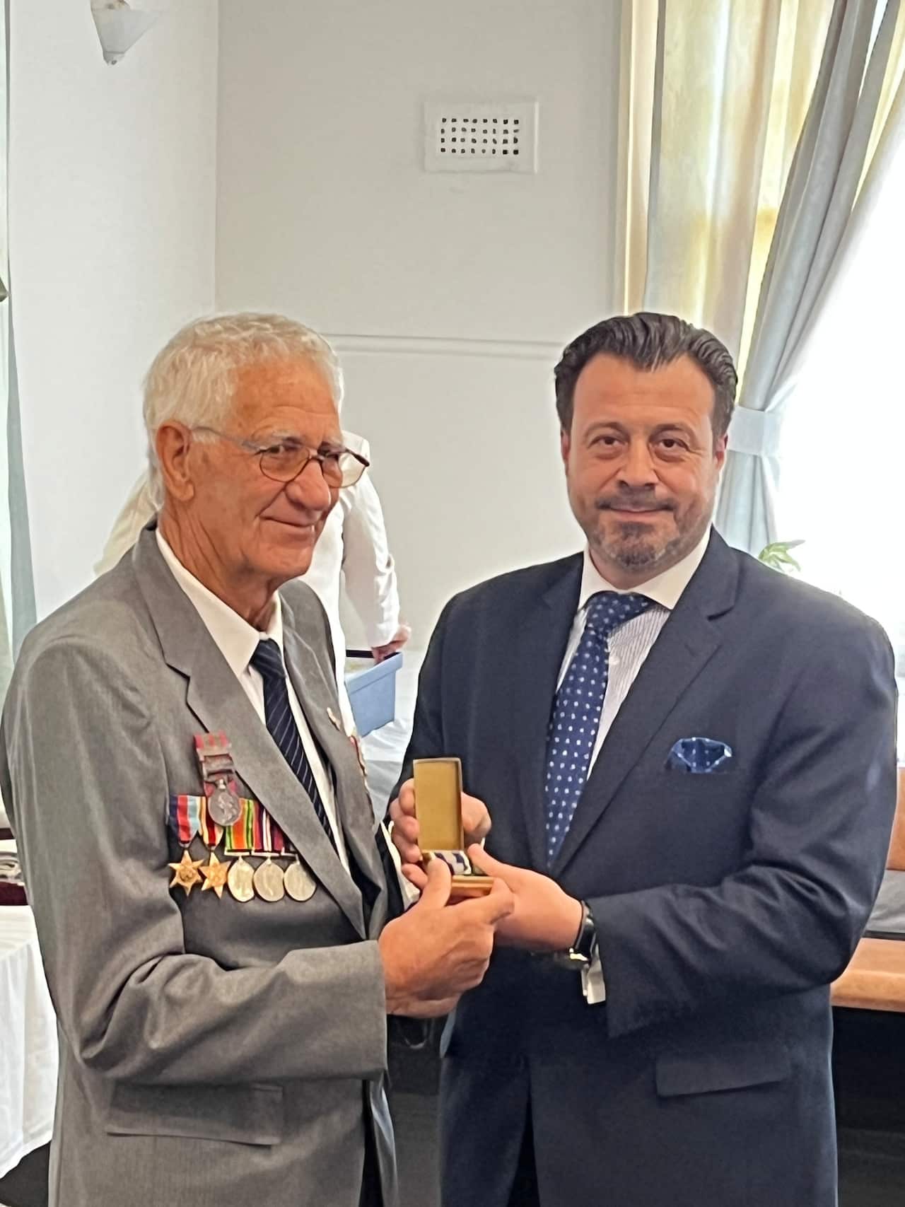 R: Consul General of Greece in Melbourne Emmanuel Kakavelakis with one of the descendants of the 40 veterans