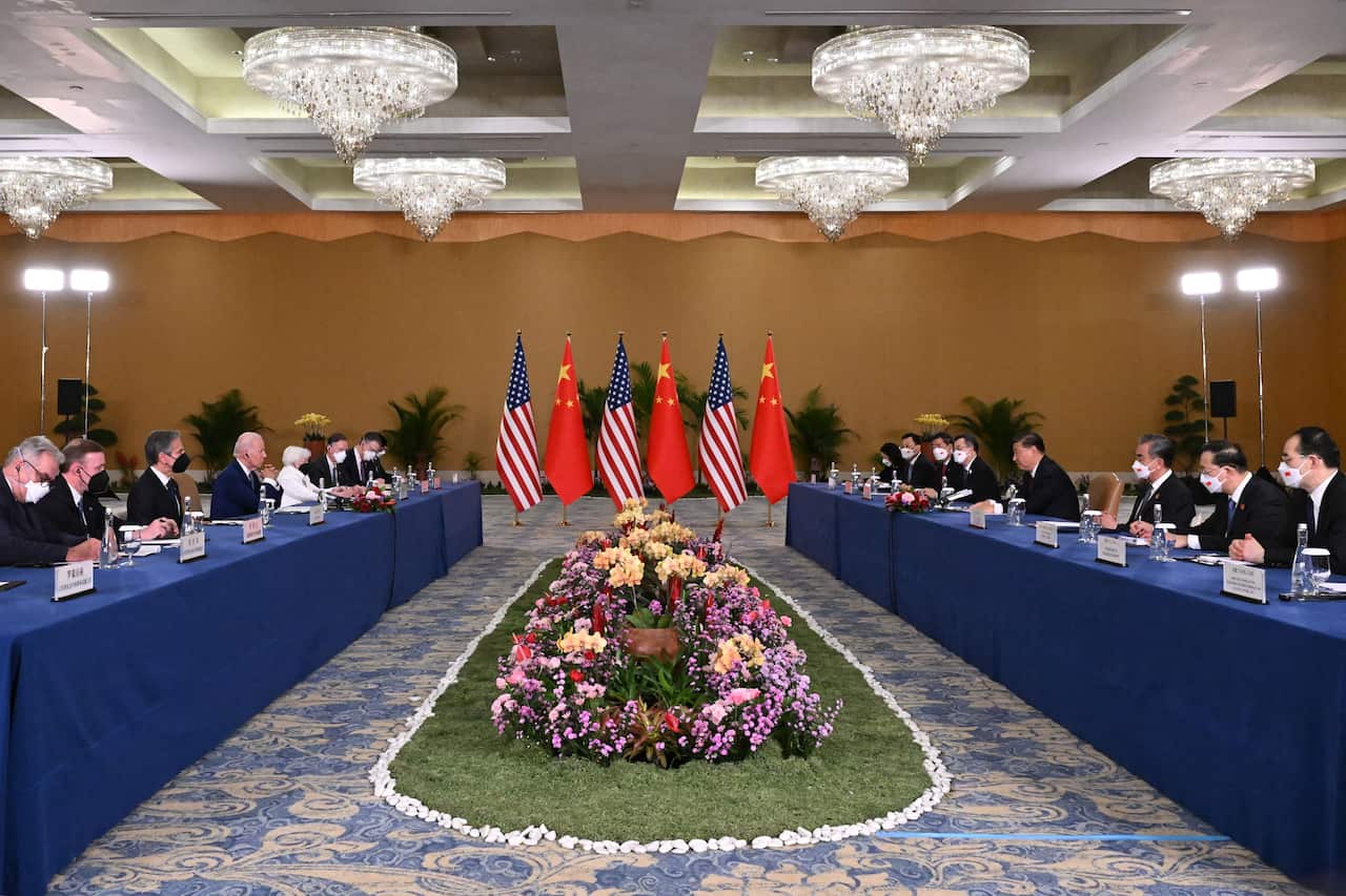 Presidents Biden and Xi, along with their respective delegations, sit facing each other at the G20 Summit