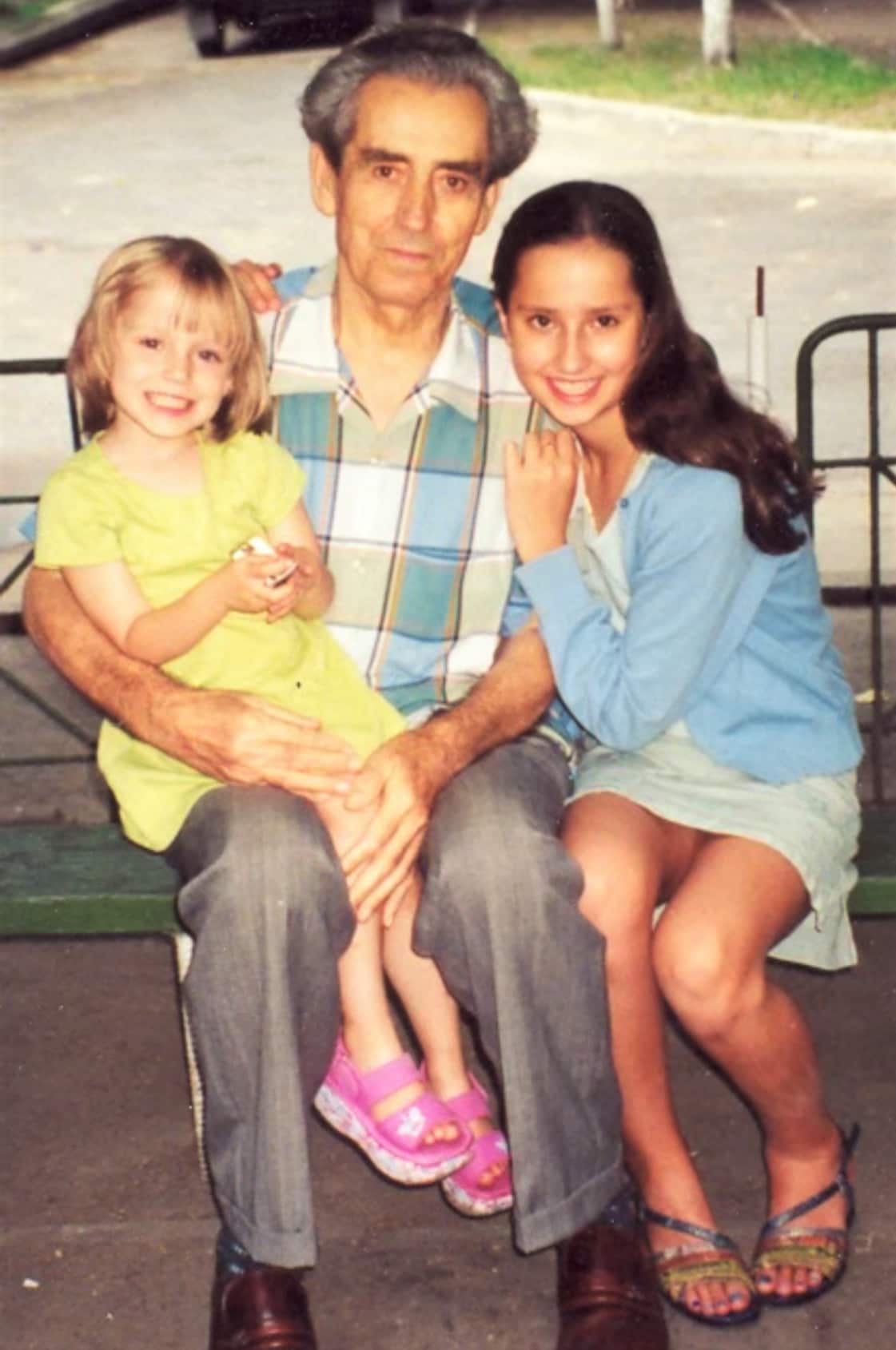 Kateryna (right) aged 12 in Ukraine with her grandfather and sister. 