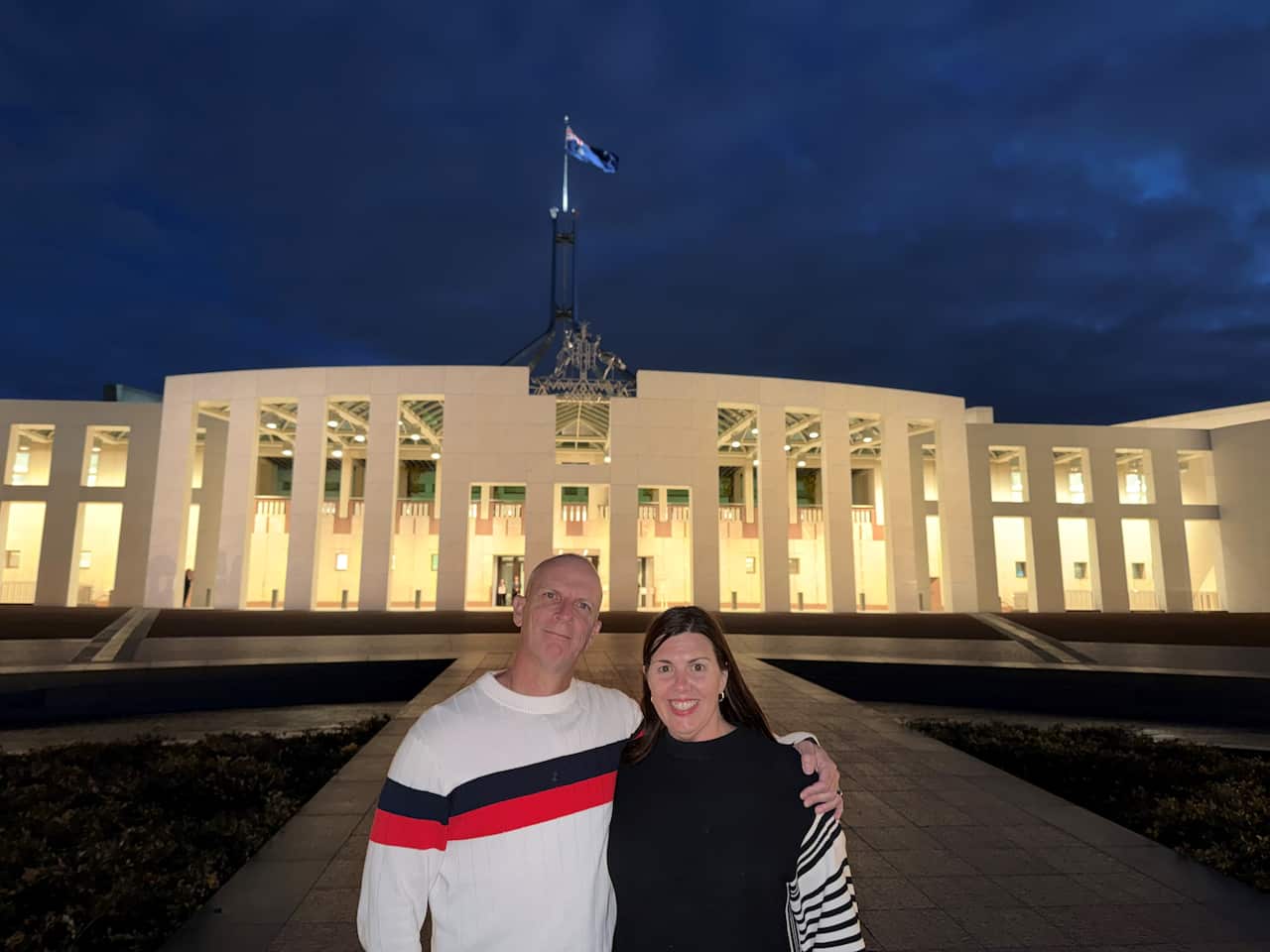 Rachel Condos-Fields with her partner Glen Fields in front of the Federal Parliament in Canberra