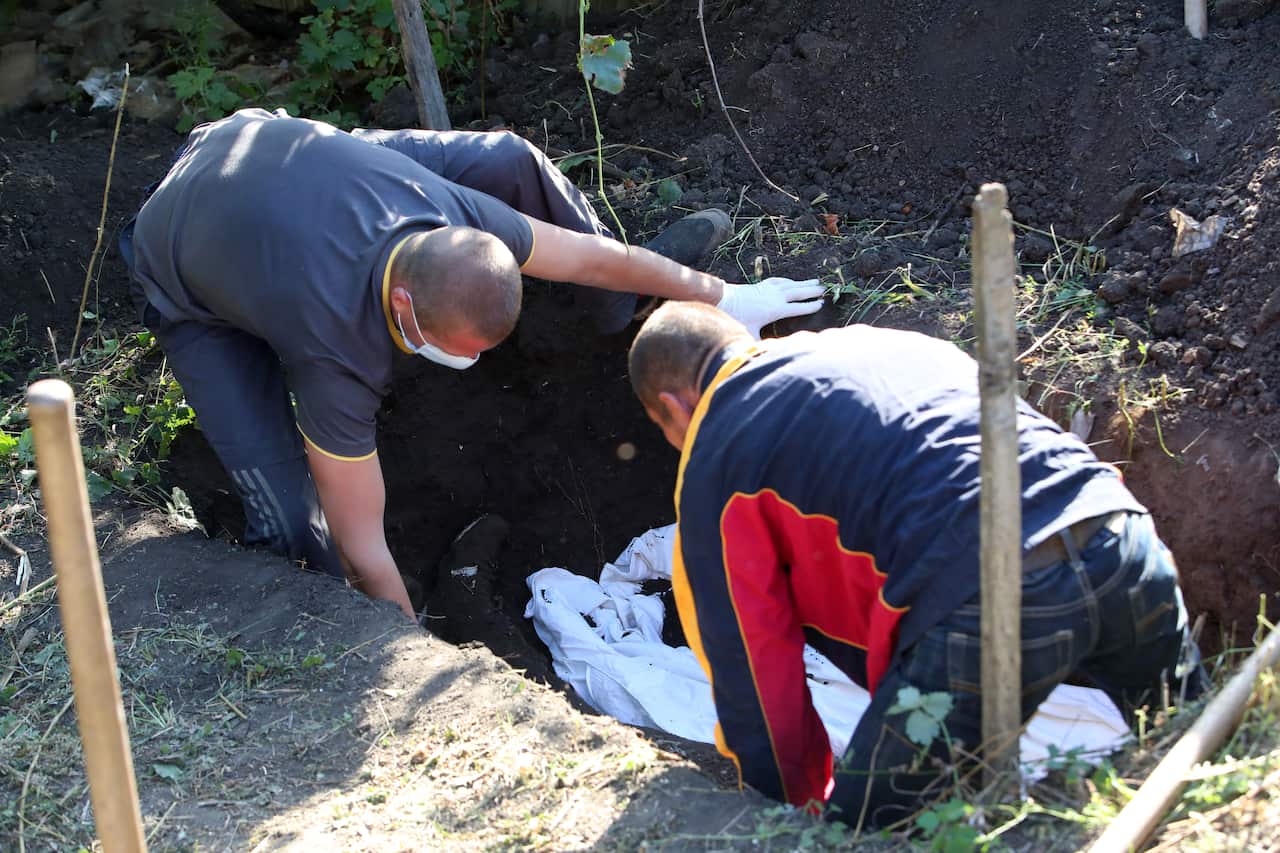 Exhumation of bodies of men killed during Russian occupation of now liberated village in Kharkiv Region