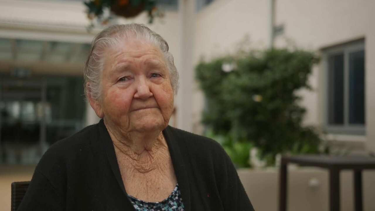 Barbara Macgregor sitting outside her aged care home in Sydney