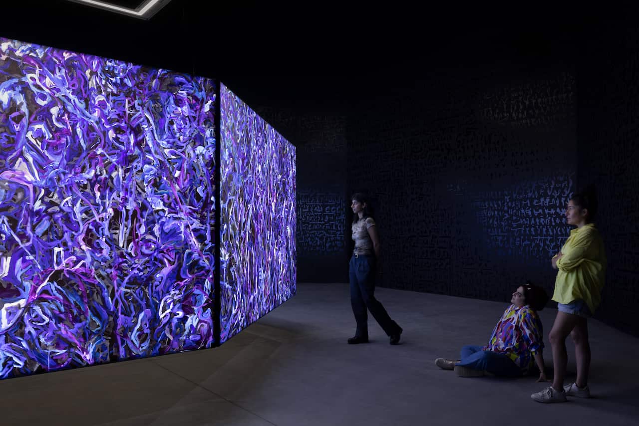 Khaled Sabsabi's conference of one's self, an immersive installation artwork featuring large projection panels.
