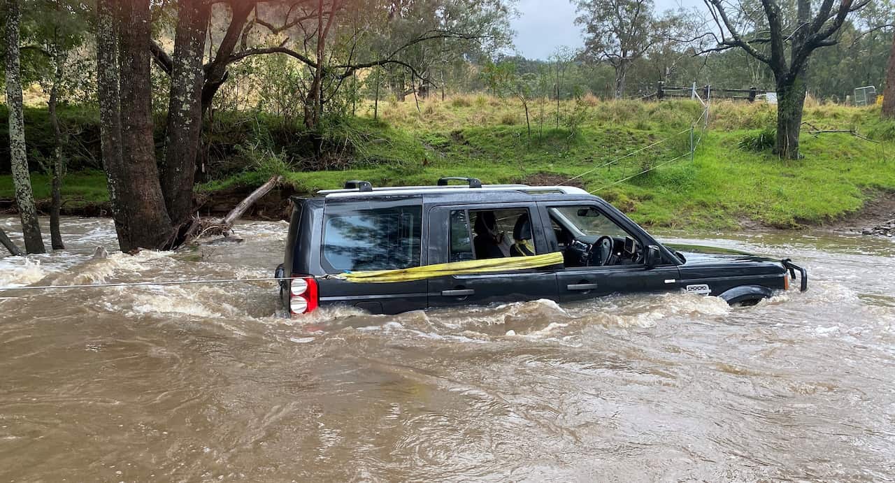 A car stuck in floodwaters. 