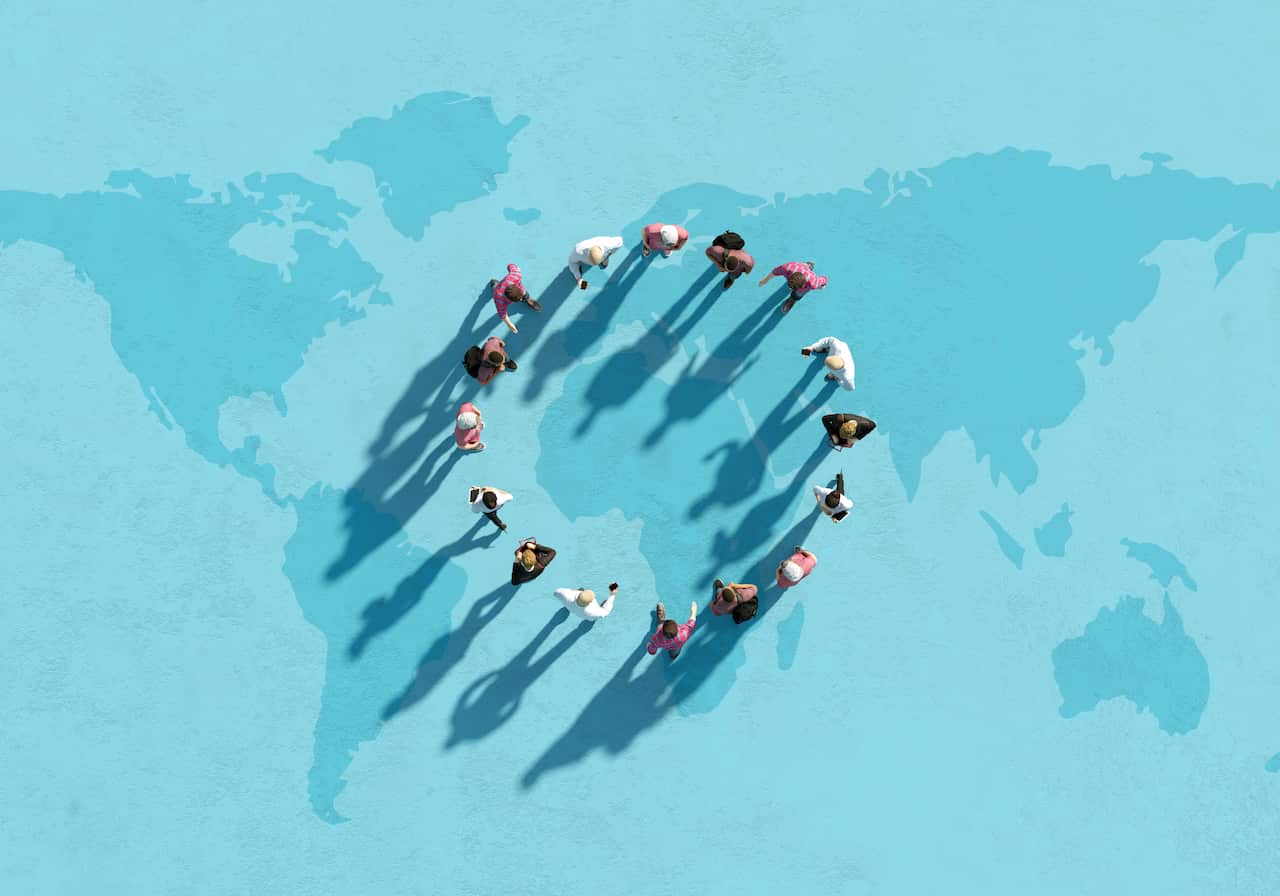 A graphic showing people standing in a circling and their shadows cast on the ground which shows a map of the earth.