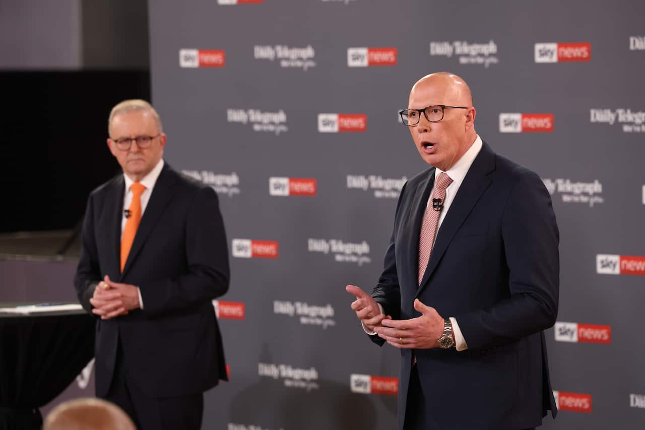 Anthony Albanese watches Peter Dutton speak 