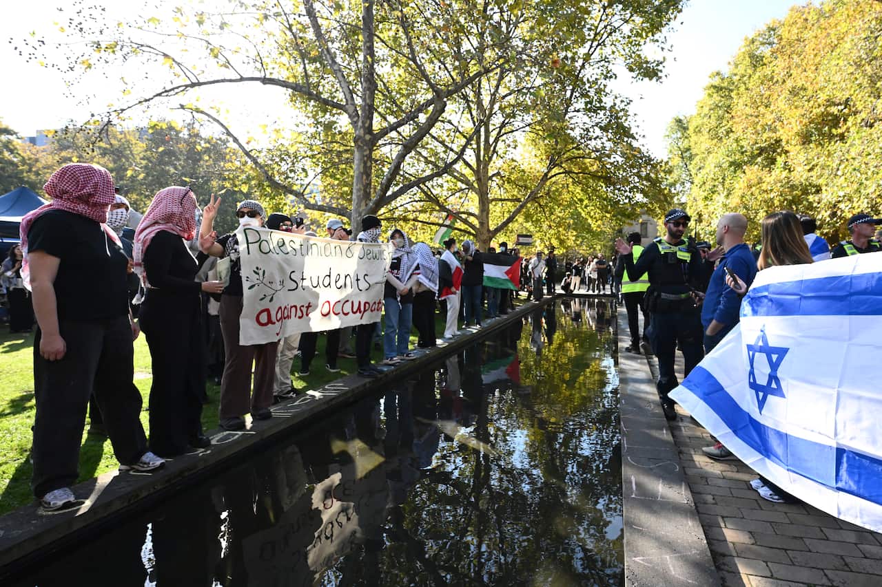 Pro-Palestinian protesters stand opposite pro-Israel protesters on a university campus.