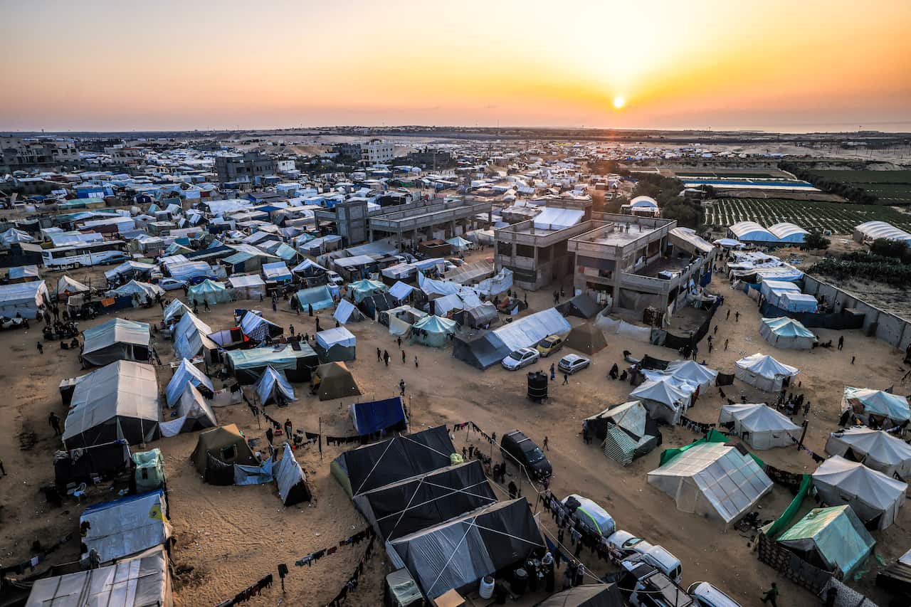 The sun setting over Egypt across the border from the tent camps of displaced Palestinians in Rafah.