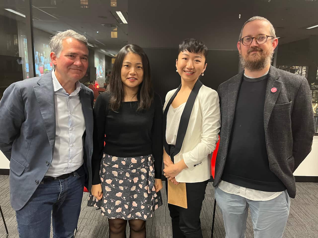 Group of four people standing together.