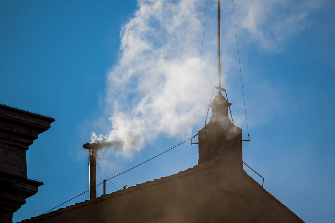 White smoke is coming out from the Sistine Chapel.