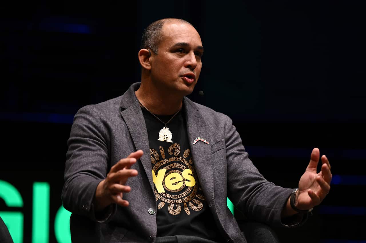 Man in blazer speaking.