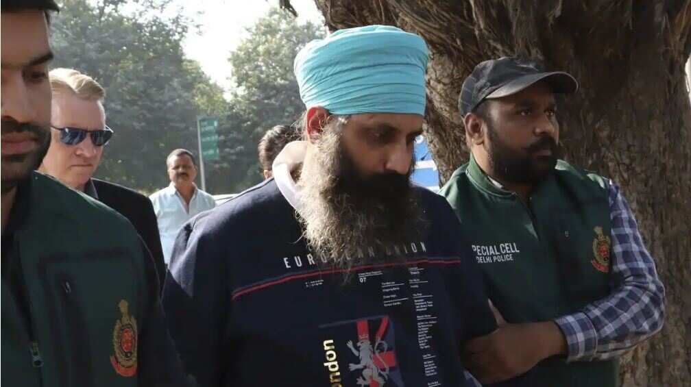Policemen escort Rajwinder Singh, 38, after he was arrested in New Delhi in November last year. He is accused of killing Australian woman Toyah Cordingley, 24, in Queensland in 2018. Source: AAP, AP / 