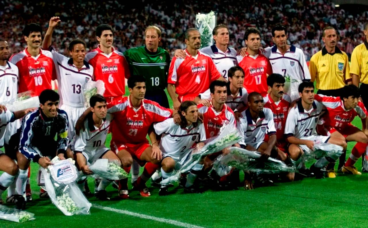 Team photo of white and red jersey-wearing men. 