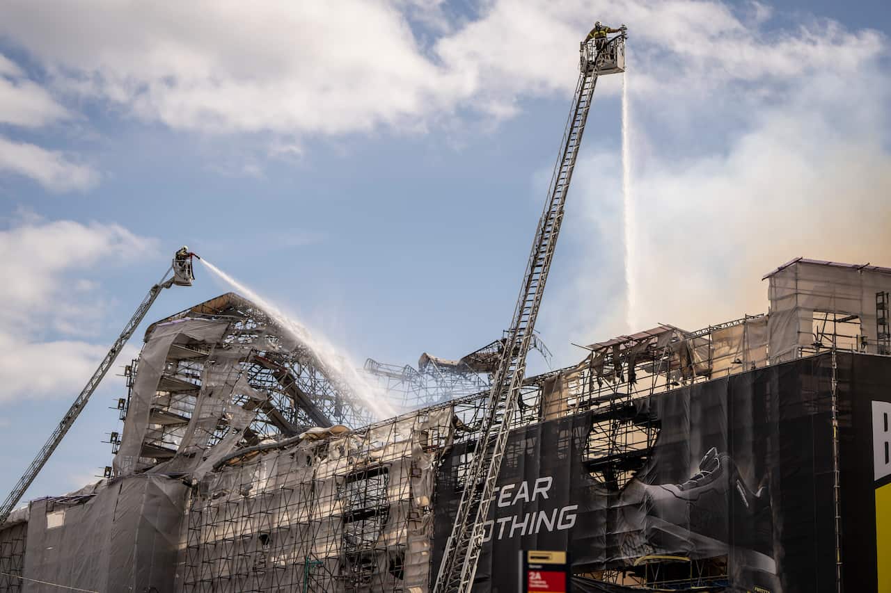 Firefighters extinguish a fire at the Stock Exchange in Copenhagen.