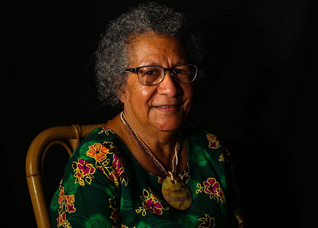 A woman smiles at the camera