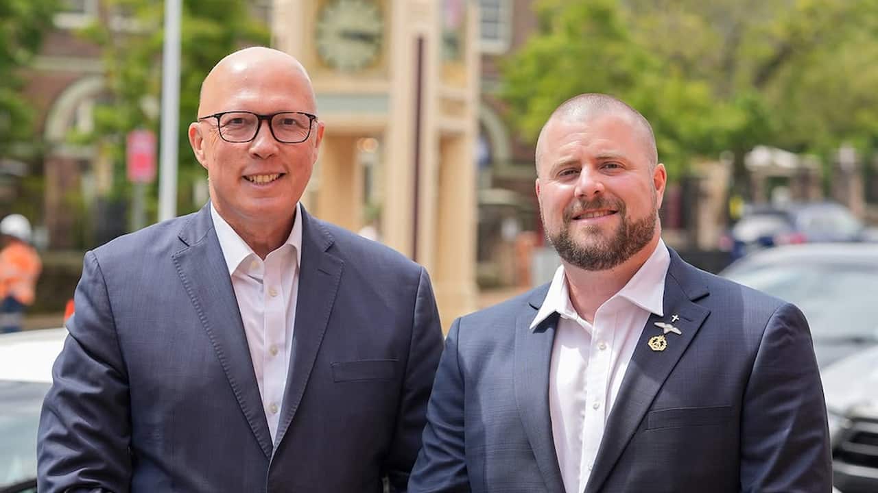 Peter Dutton and Benjamin Britton, both wearing white shirts and blazers, standing next to each other outside.