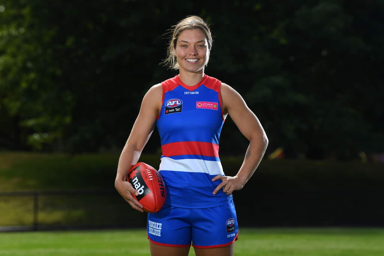 Western Bulldogs captain Ellie Blackburn poses with an AFL football.