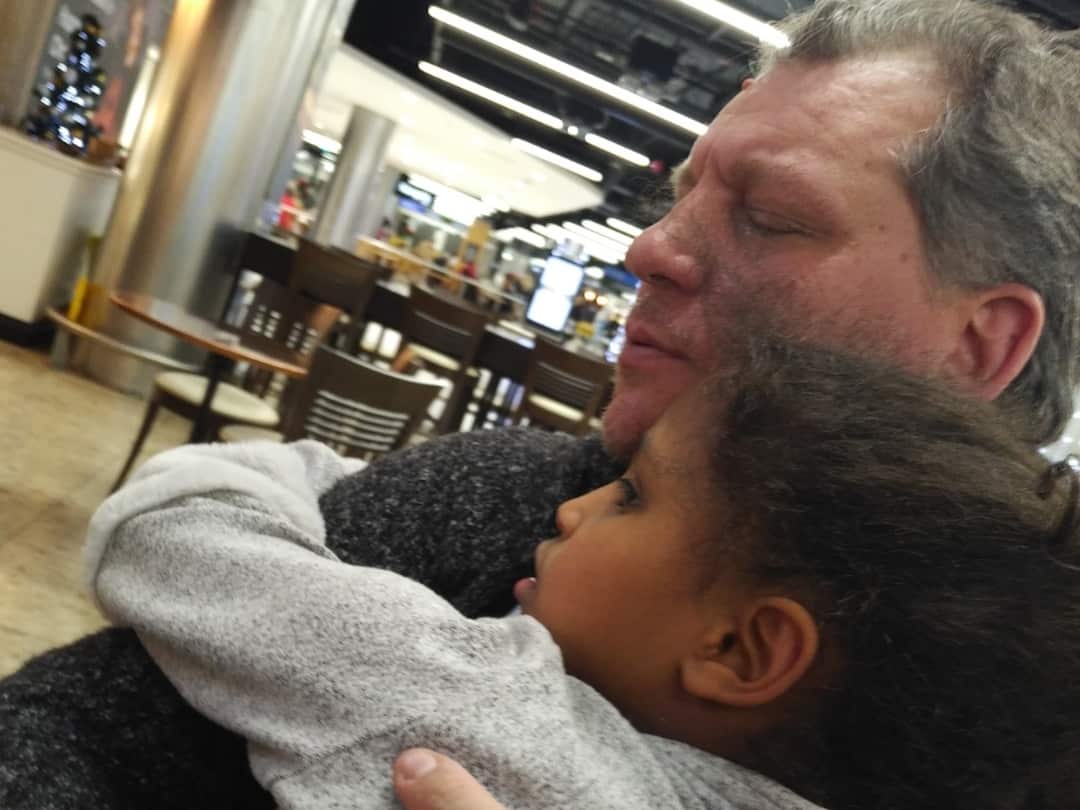 Man and young girl hugging