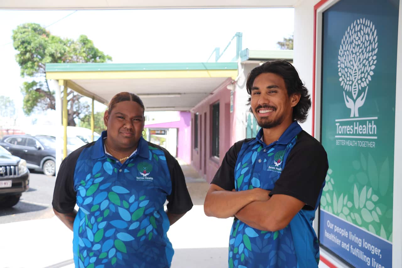 Rashae and Oshan stand in the street of Waiben, Thursday Island, outside their office.