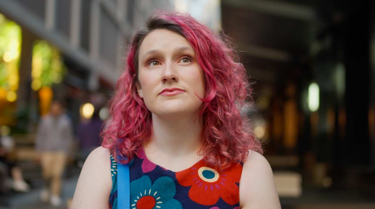 A woman looks up to the sky. 