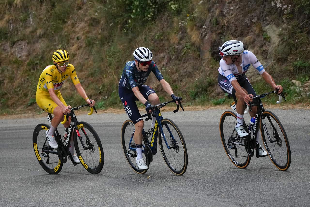 Three men are riding bicycles on a steep mountain.