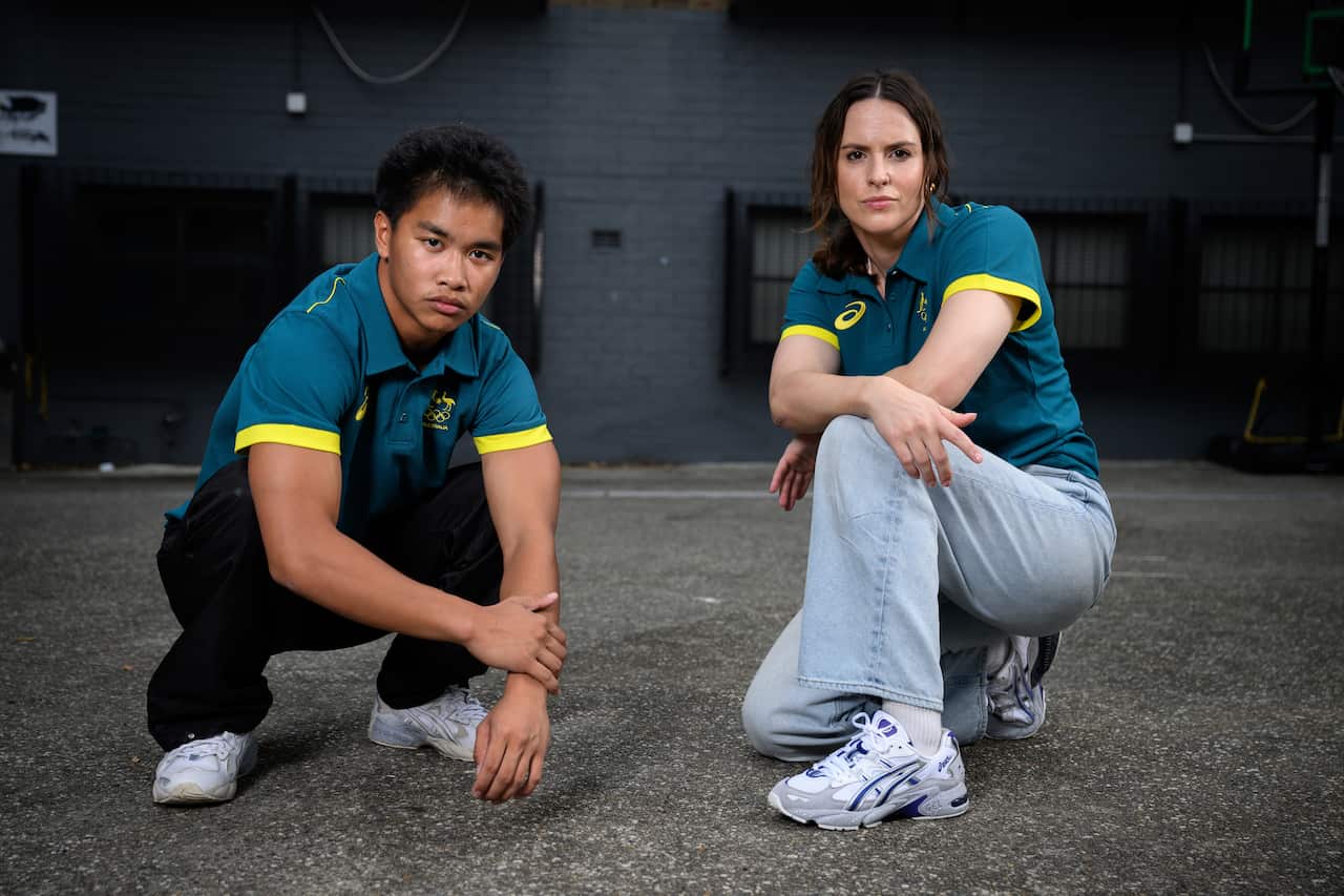 Two athletes pose for the camera