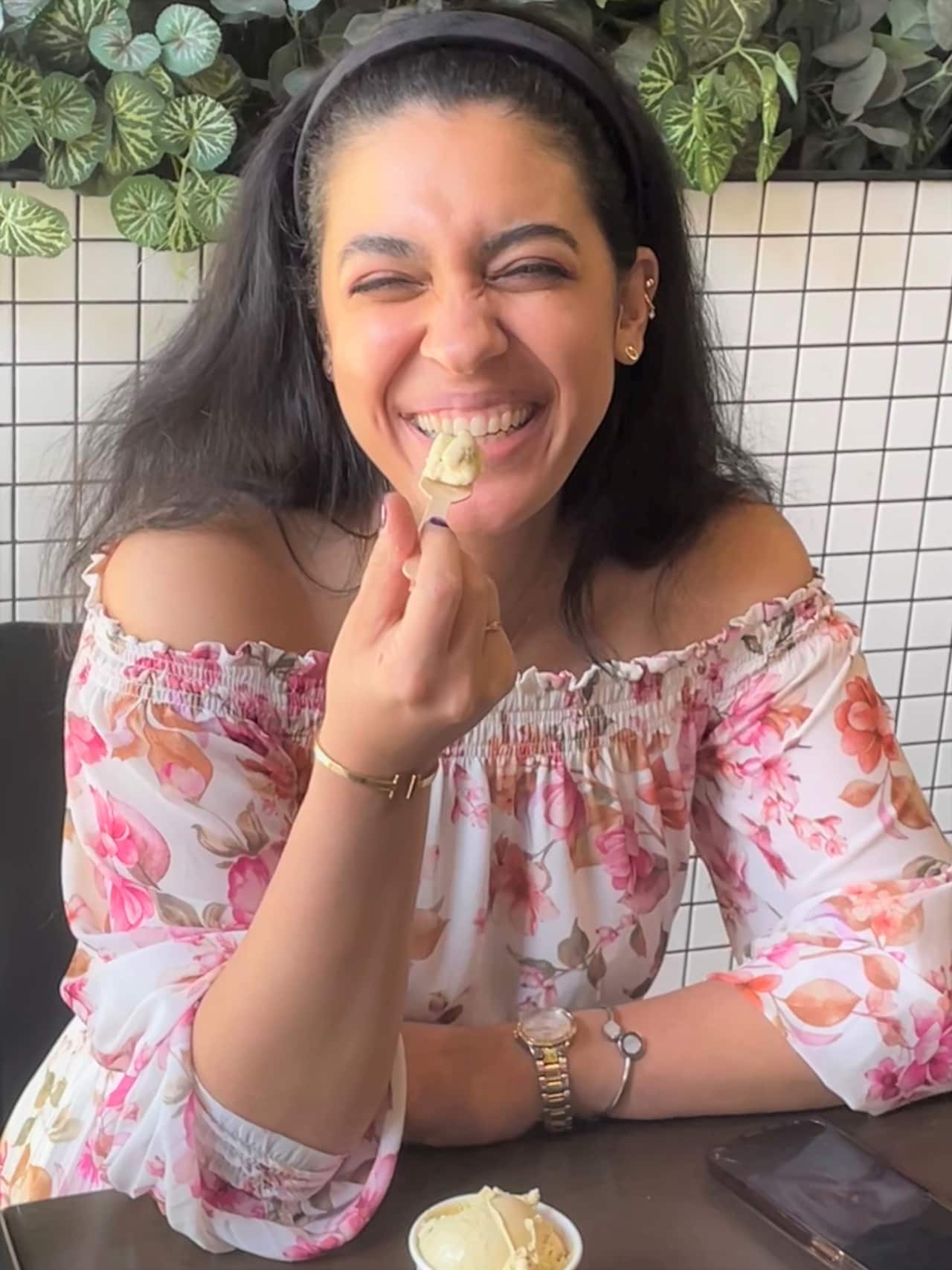 Customer Sara Naghizadeh smiles as she tastes a scoop of pistachio gelato.
