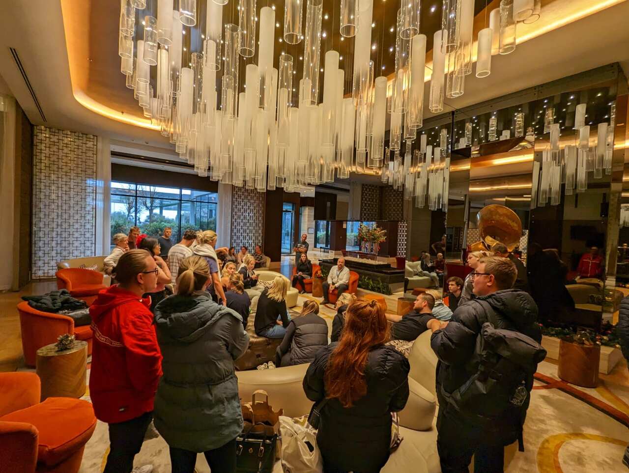 A crowd of people in a hotel lobby.