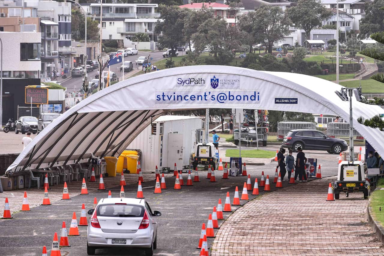 A car driving up to a large tent