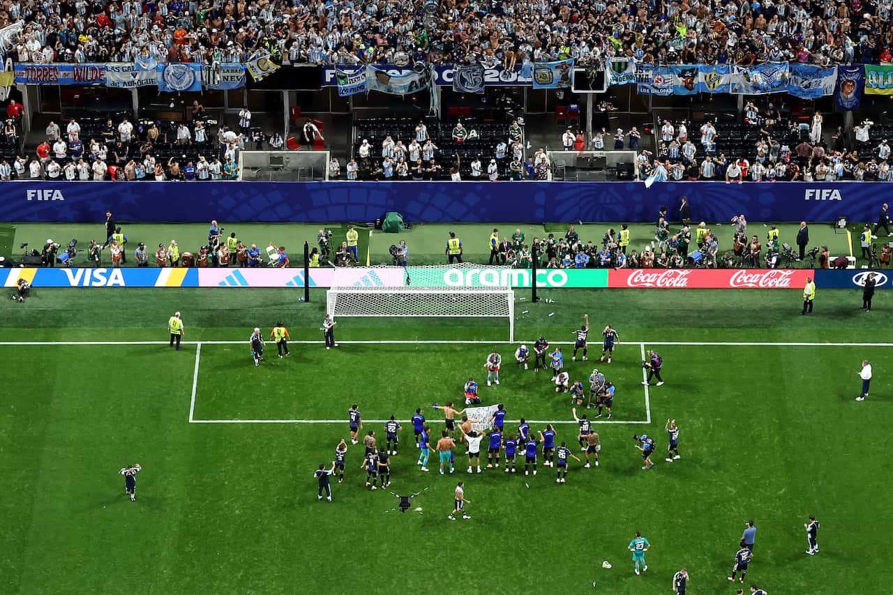 Argentine football players celebrating in front of the Argentine stand 