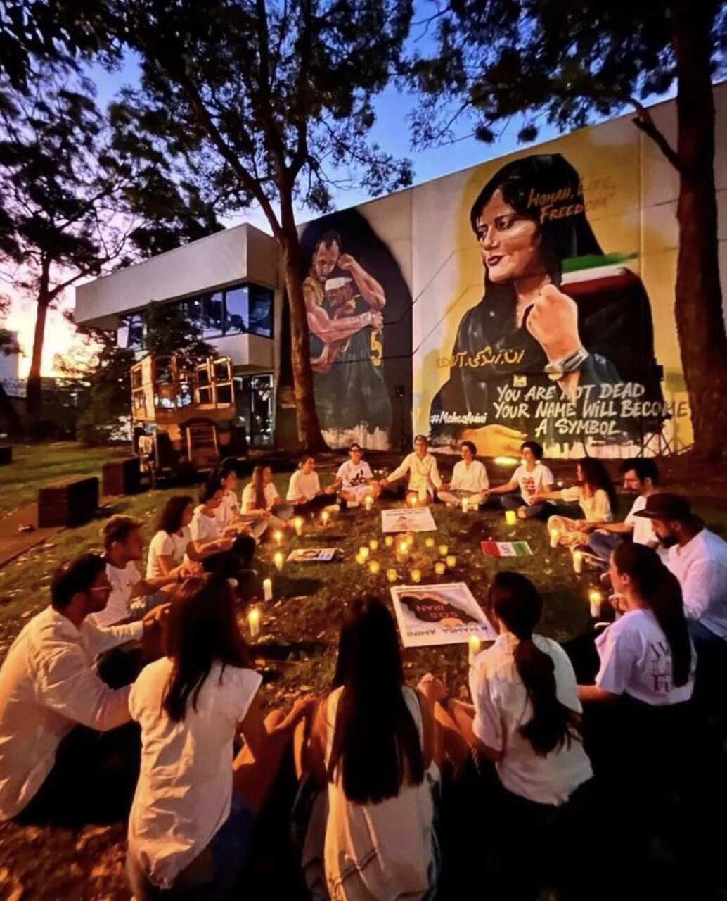 A group of people, gathering in front of Mahsa Amini Mural in Sydney
