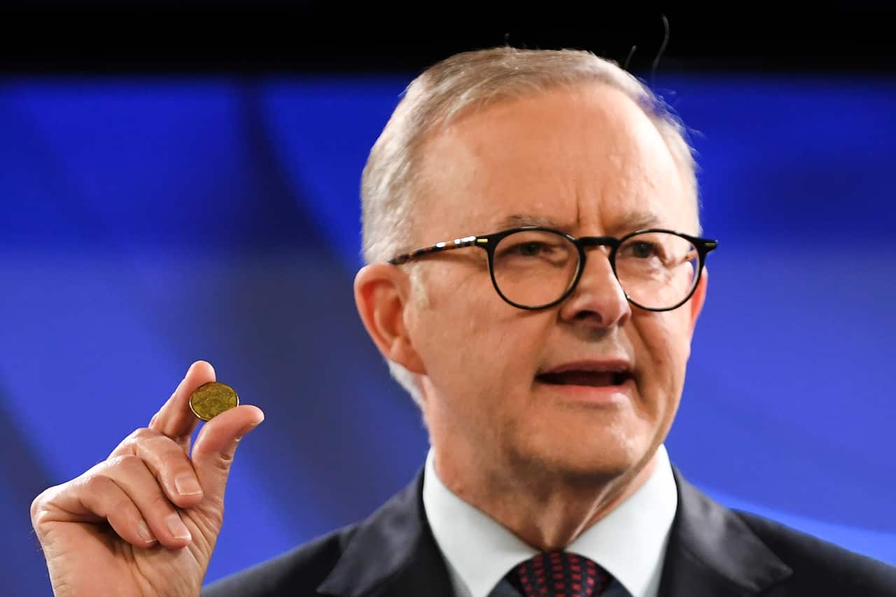 Anthony Albanese holding gold coin
