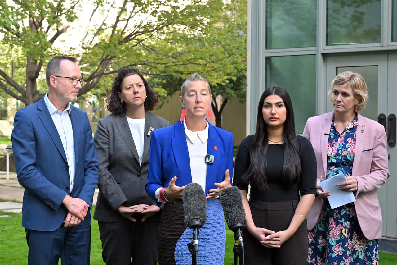 A group of people giving a press conference.