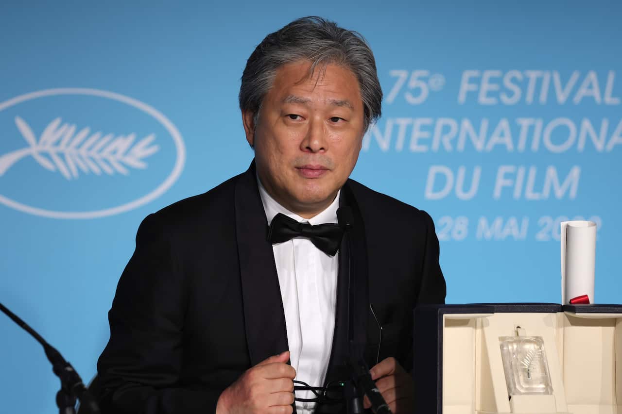 A man in a suit at a Cannes Film Festival press conference.