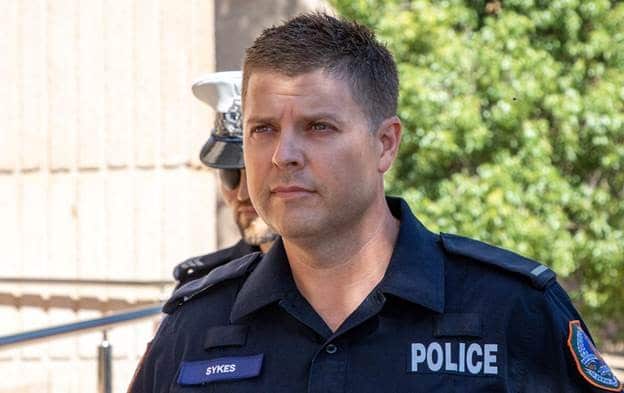 Photo of Constable Mark Sykes entering the Alice Springs local Court