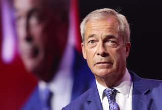 Nigel Farage, wearing a blue jacket, white shirt and blue tie.