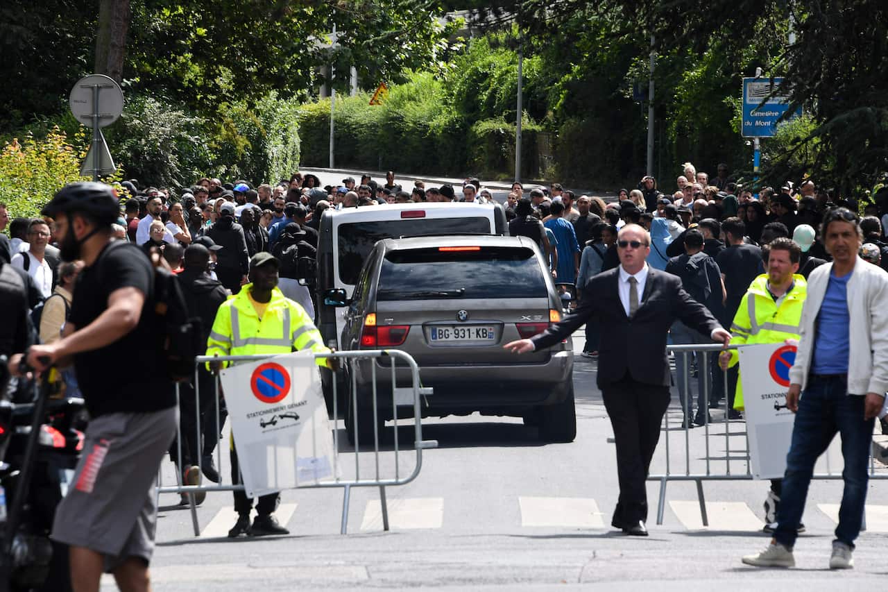 Authorities patrol a funeral at Mont Valerien cemetery in Paris.