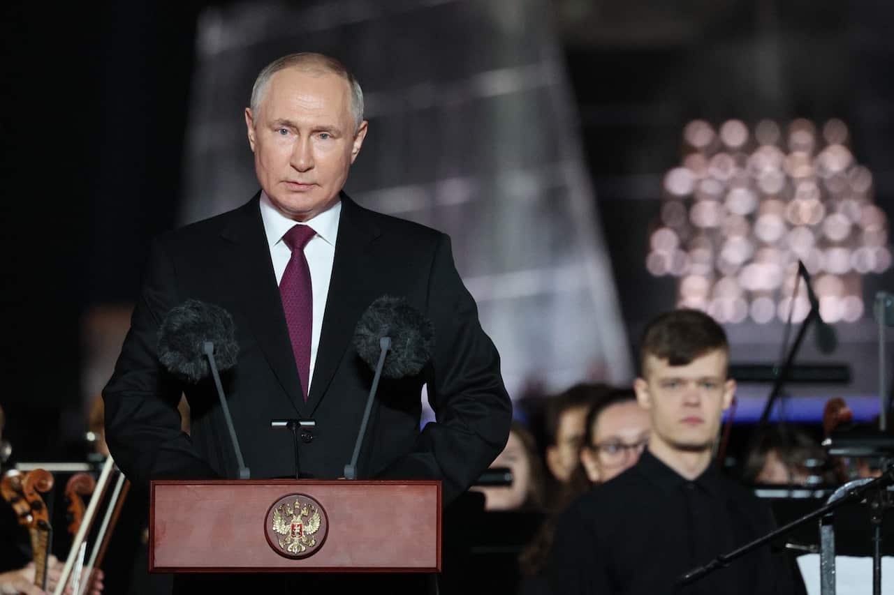 Vladimir Putin speaking at a podium